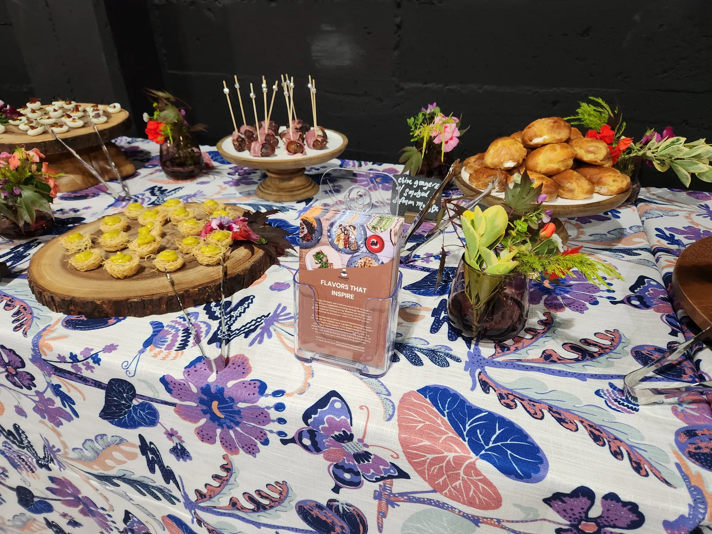 A Hungry Kitchens catering spread — canapés and pastries on wooden boards